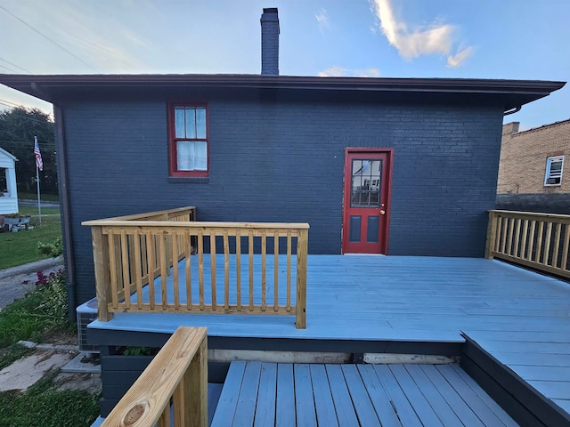 back of property featuring a wooden deck