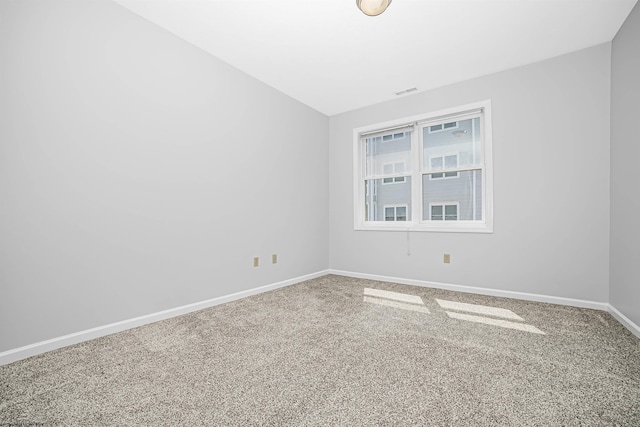 unfurnished room featuring carpet flooring and baseboards