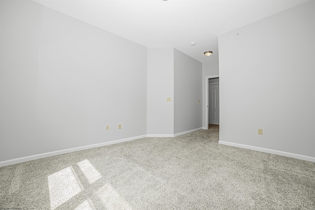 carpeted empty room with baseboards