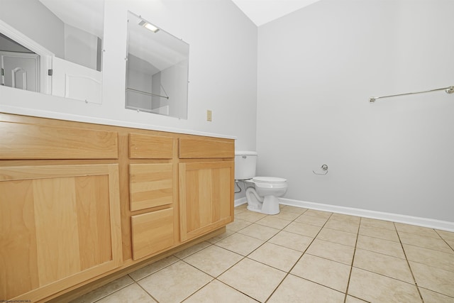 bathroom with tile patterned flooring, toilet, and baseboards