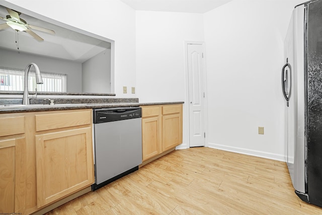 kitchen featuring dark countertops, light wood-style flooring, light brown cabinets, and appliances with stainless steel finishes