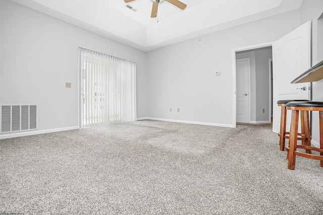 living room featuring carpet floors, visible vents, and baseboards