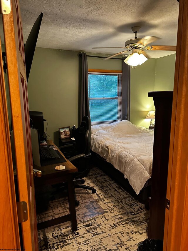 bedroom with a textured ceiling and ceiling fan