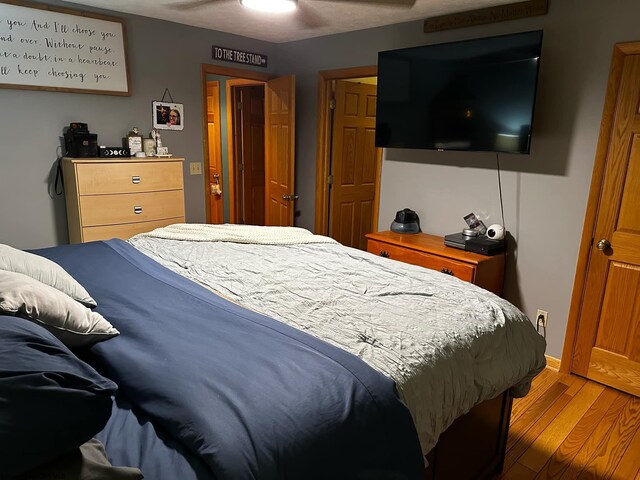 bedroom with ceiling fan and dark wood-type flooring