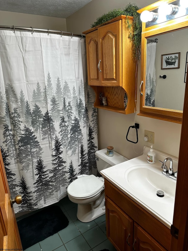 bathroom with a textured ceiling, tile patterned flooring, vanity, toilet, and a shower with curtain