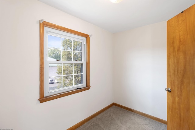 carpeted spare room with baseboards