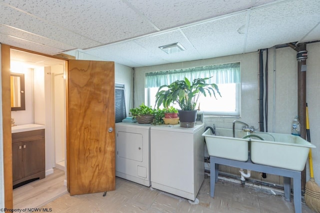 laundry area with light floors, laundry area, visible vents, and washing machine and clothes dryer