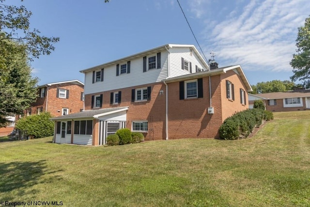 rear view of house with a yard