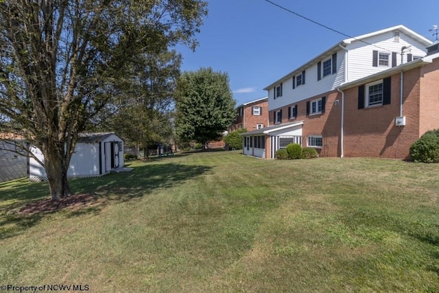 view of yard featuring a storage shed, an outdoor structure, and a sunroom