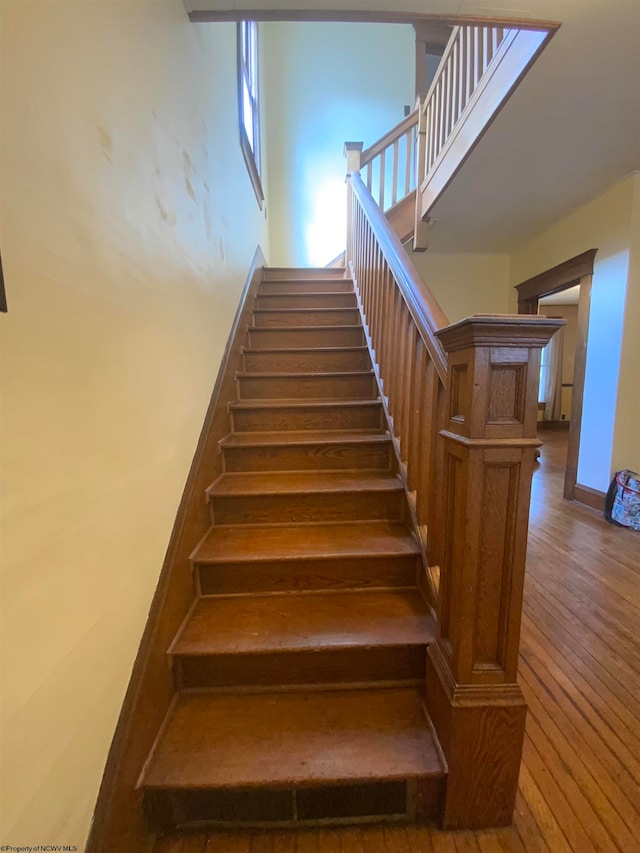 stairway with hardwood / wood-style flooring