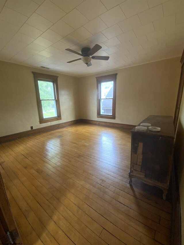 spare room featuring ceiling fan and light hardwood / wood-style flooring