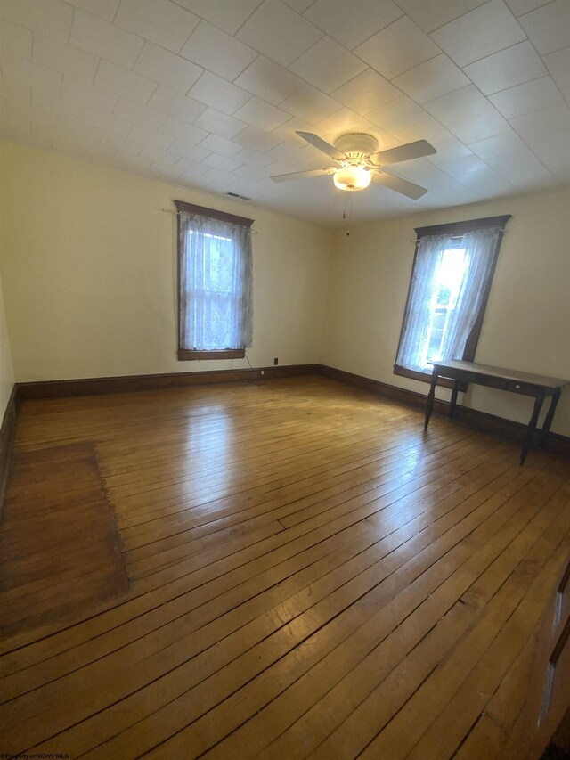 unfurnished room featuring ceiling fan and light hardwood / wood-style floors