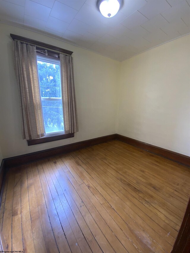 unfurnished room with wood-type flooring