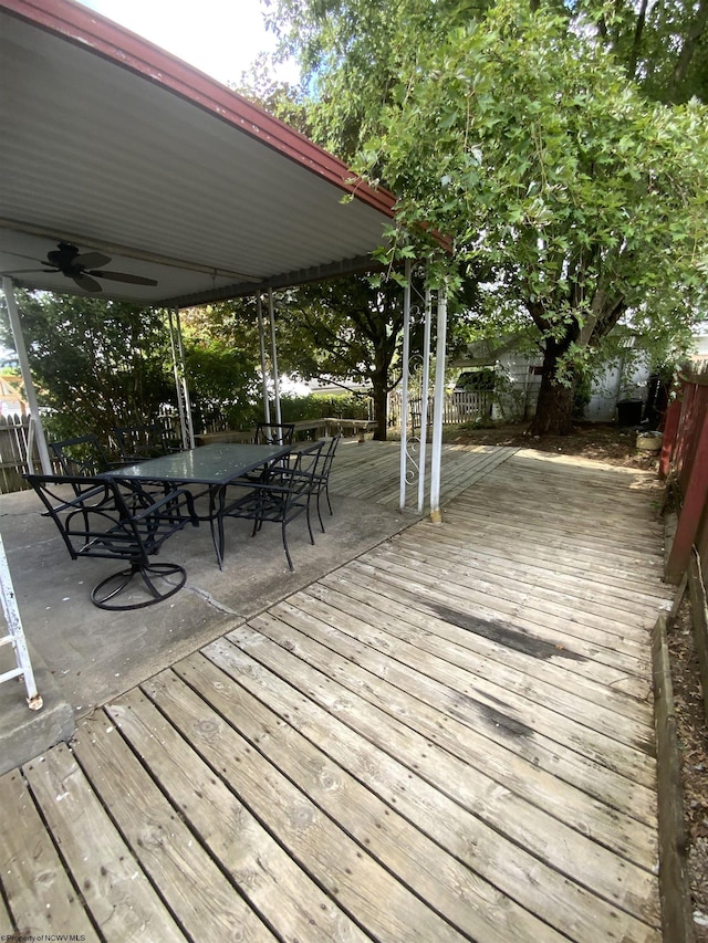 deck featuring outdoor dining space, fence, and a ceiling fan