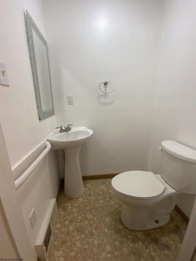 bathroom featuring toilet, baseboards, and visible vents