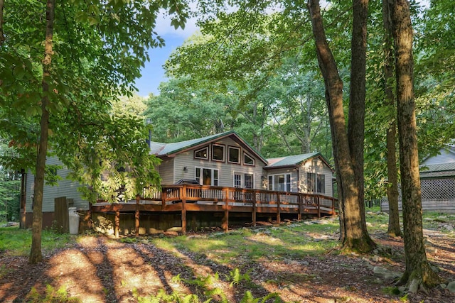 rear view of house featuring a wooden deck