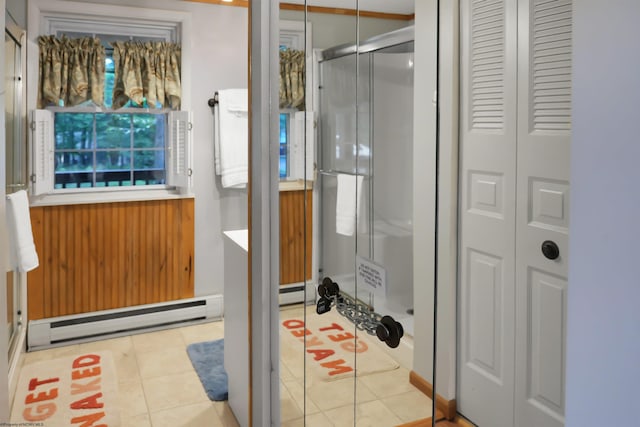 bathroom featuring tile patterned floors, a shower with door, and a baseboard radiator