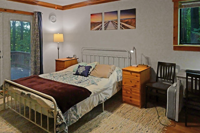 bedroom featuring ornamental molding and wood-type flooring