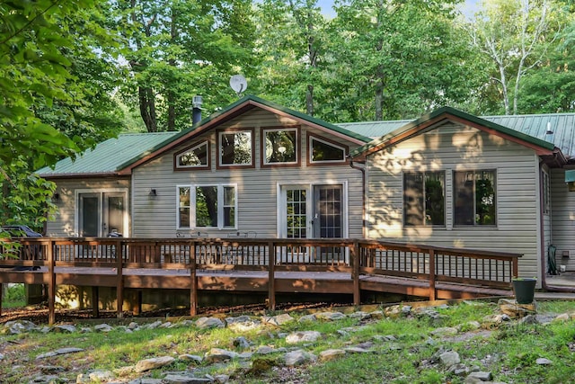 rear view of property featuring a wooden deck