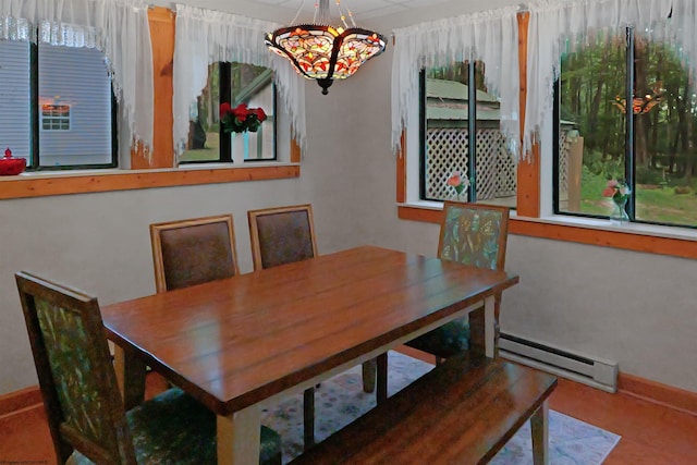 dining area with an inviting chandelier and a baseboard radiator