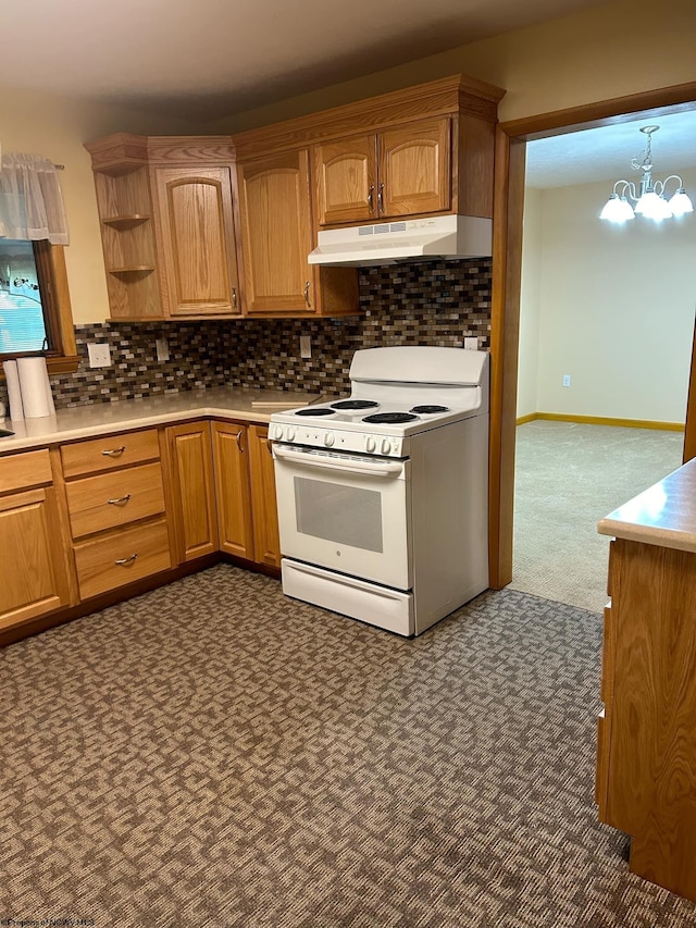 kitchen featuring electric stove, brown cabinets, tasteful backsplash, light countertops, and under cabinet range hood