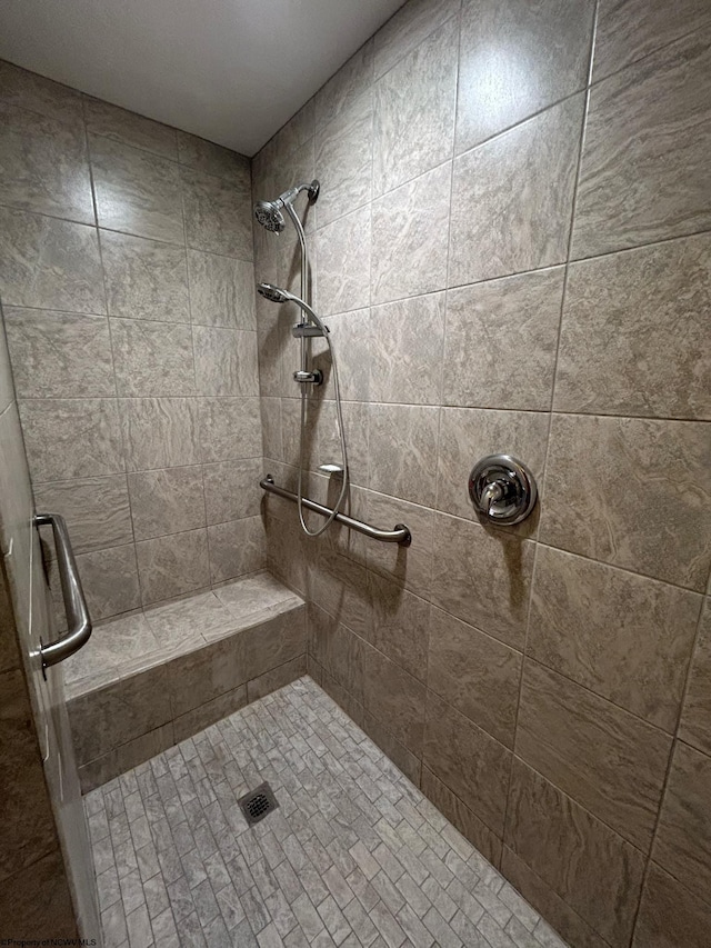 full bathroom with a tile shower