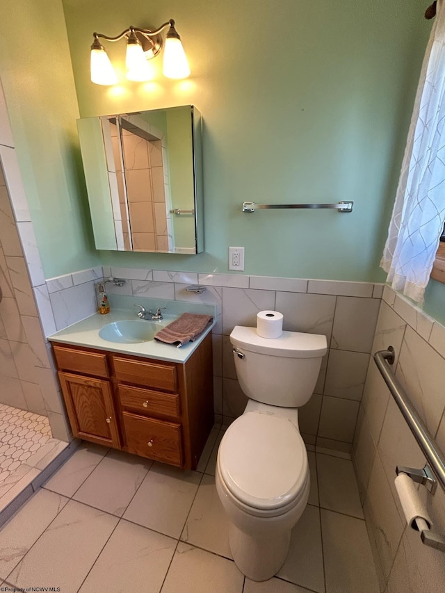 full bathroom with wainscoting, tile walls, and toilet