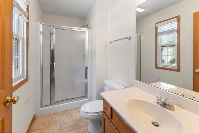 bathroom featuring tile patterned flooring, toilet, vanity, and walk in shower