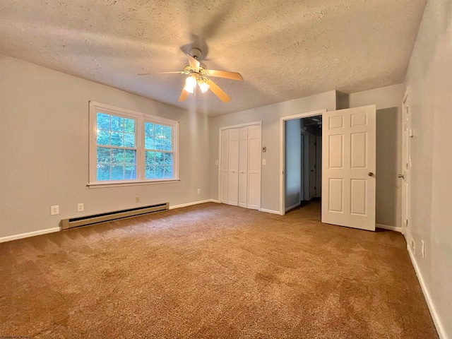 unfurnished bedroom with carpet, a textured ceiling, baseboard heating, ceiling fan, and a closet