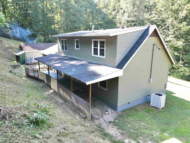 rear view of property featuring central air condition unit and a wooden deck