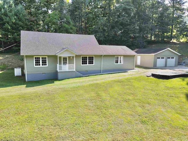 ranch-style home featuring an outbuilding, covered porch, a front yard, and a garage