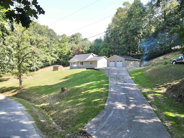 ranch-style house featuring a front lawn, a garage, and a storage unit