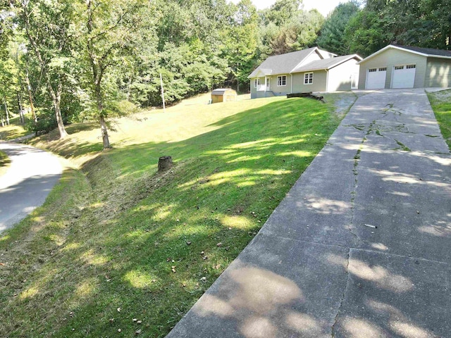 view of front of home featuring a front yard, a garage, and a storage unit