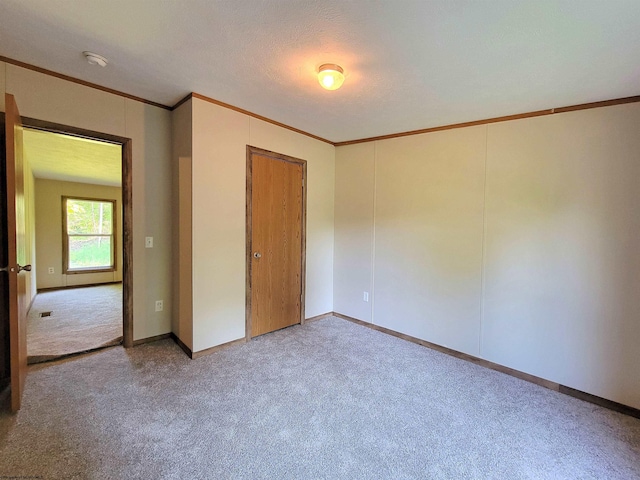 unfurnished bedroom with light carpet and crown molding