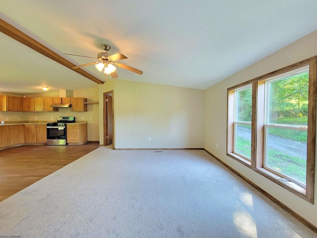 unfurnished living room featuring a wealth of natural light, ceiling fan, and hardwood / wood-style floors