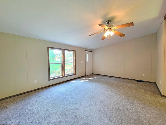 carpeted spare room featuring ceiling fan