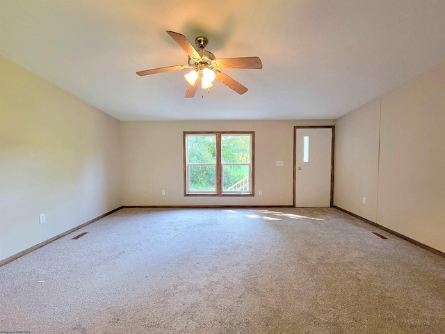 carpeted spare room with ceiling fan