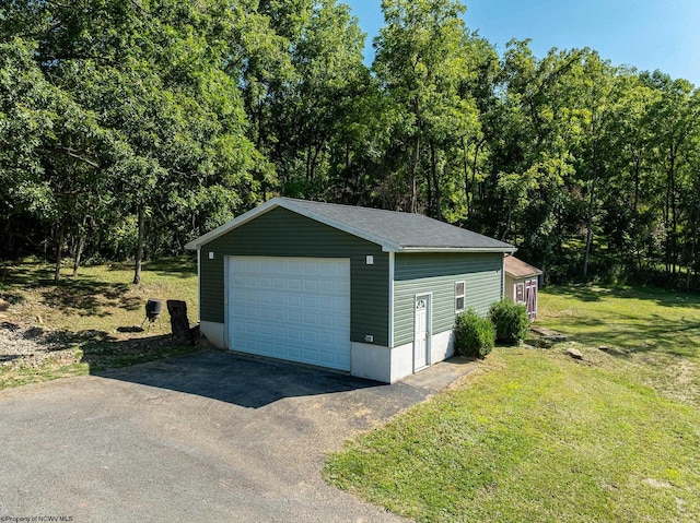 garage featuring a yard