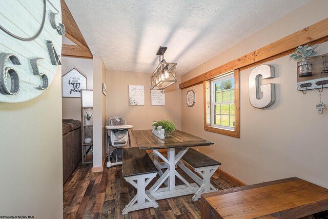 dining room featuring a textured ceiling and dark wood-type flooring