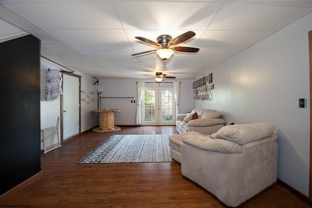 living room featuring ceiling fan, a drop ceiling, french doors, and dark hardwood / wood-style flooring