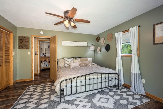 bedroom with ceiling fan, dark wood-type flooring, and a closet