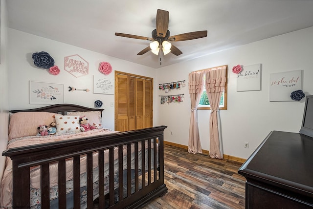 bedroom with ceiling fan, dark wood-style flooring, a closet, and baseboards