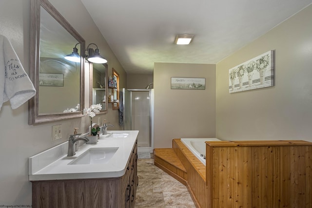 full bathroom featuring double vanity, a garden tub, a shower stall, and a sink