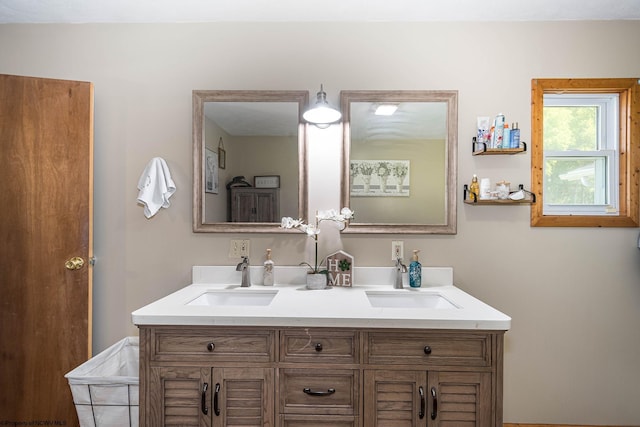 full bathroom with double vanity and a sink