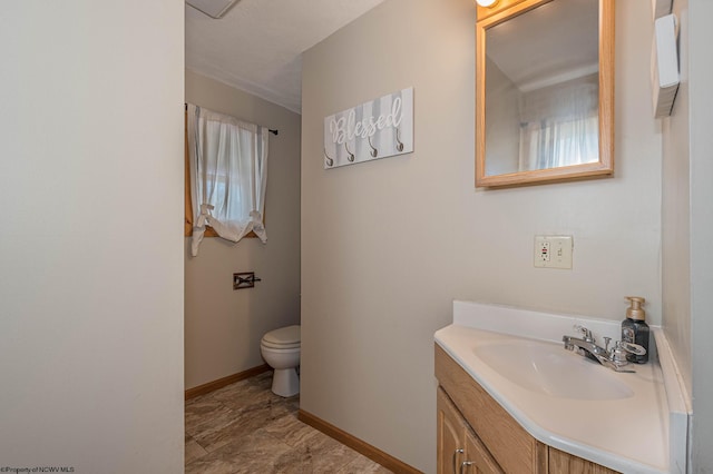 bathroom featuring toilet, vanity, and tile patterned floors