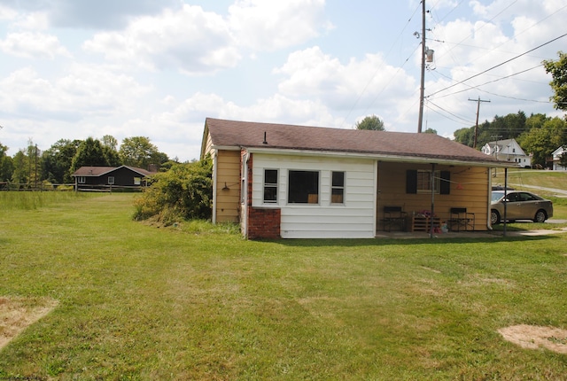 rear view of house featuring a yard