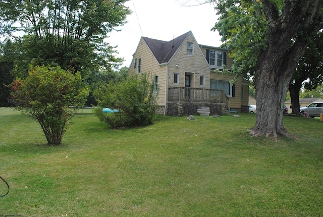 view of side of property featuring stone siding and a yard