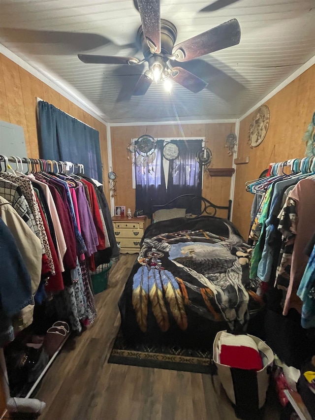 bedroom featuring crown molding, wood-type flooring, and ceiling fan