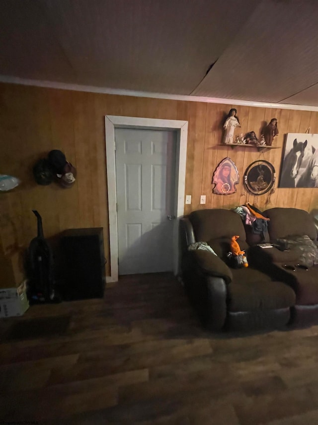 living room with wood walls, hardwood / wood-style flooring, and ornamental molding