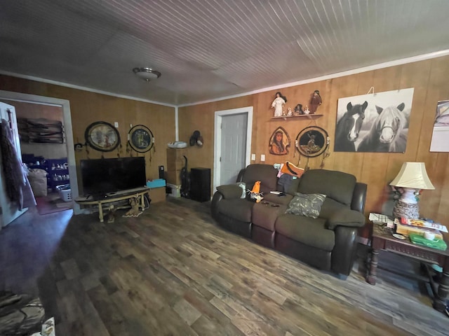 living room featuring crown molding, wood-type flooring, and wood walls